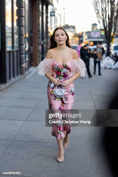 Maddie Ziegler wears rose pink off shoulder dress, mini bag, pointed heels outside Rodarte during New York Fashion Week on February 10, 2023 in New...