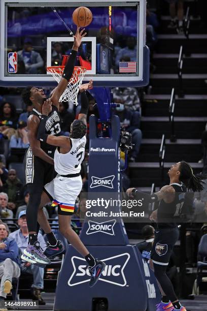 Jaren Jackson Jr. #13 of the Memphis Grizzlies blocks the shot of Jaden McDaniels of the Minnesota Timberwolves during the second half at FedExForum...