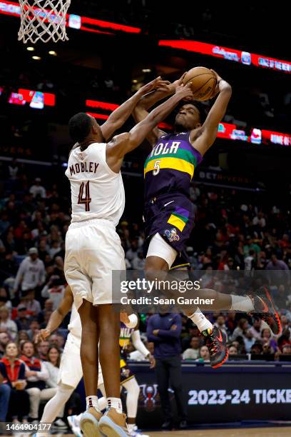 Herbert Jones of the New Orleans Pelicans dunks the ball over Evan Mobley of the Cleveland Cavaliers during the second quarter of an NBA game at...