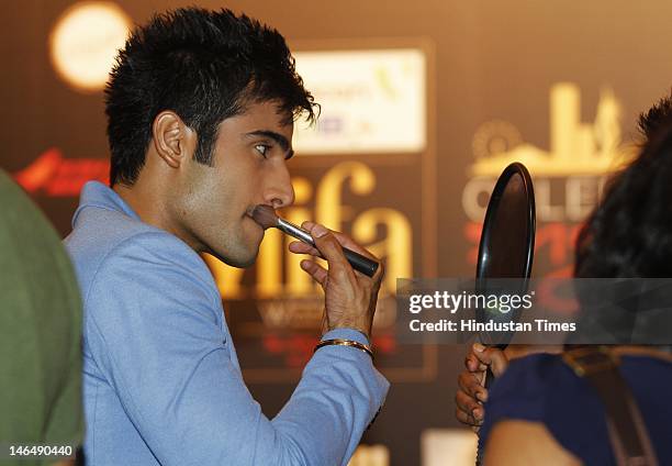 Television actor Karan Tacker fixing his makeup at IIFA Rocks green carpet on the 2nd day of 13th International Indian Film Academy Awards on June 8,...