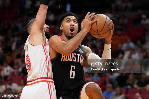 Kenyon Martin Jr. #6 of the Houston Rockets drives to the basket while being defended by Caleb Martin of the Miami Heat during the first half at...