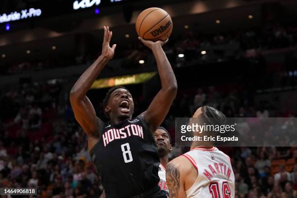 Justin Holiday of the Houston Rockets attempts a shot over Caleb Martin of the Miami Heat during the first half at Miami-Dade Arena on February 10,...