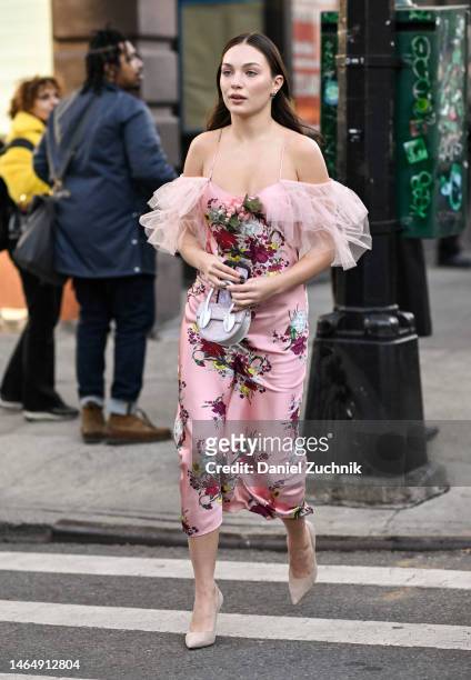Maddie Ziegler is seen wearing a Rodarte pink floral dress, tan shoes and tan and silver bag outside the Rodarte show during New York Fashion Week...