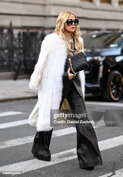 Rachel Zoe is seen wearing a white faux fur coat, black jacket and pants, Chanel bag and black sunglasses outside the Rodarte show during New York...