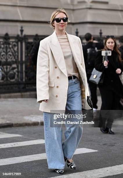 Lisa Aiken is seen wearing a white jacket, sheer top, blue jeans and black and white shoes outside the Rodarte show during New York Fashion Week F/W...