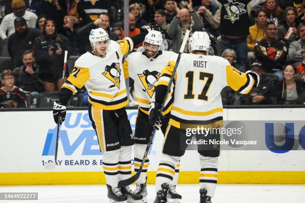 Pierre-Olivier Joseph of the Pittsburgh Penguins celebrates with teammates Bryan Rust and Evgeni Malkin after scoring a goal during the second period...