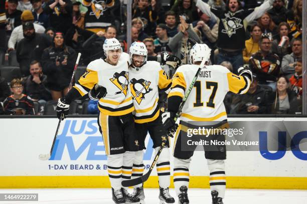 Pierre-Olivier Joseph of the Pittsburgh Penguins celebrates with teammates Bryan Rust and Evgeni Malkin after scoring a goal during the second period...