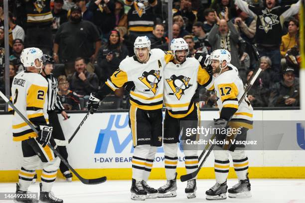 Pierre-Olivier Joseph of the Pittsburgh Penguins celebrates with teammates Bryan Rust, Evgeni Malkin and Chad Ruhwedel after scoring a goal during...