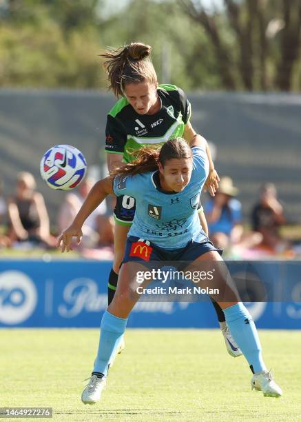 Nolan Stringer Laura Hughes of Canberra United and Sarah Hunter of Sydney FC contest ...