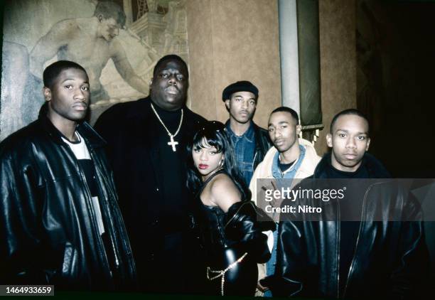 Portrait of members of R&B group 112 and American rappers Notorious BIG & Lil Kim as they pose at an unspecified restaurant, New York, New York,...