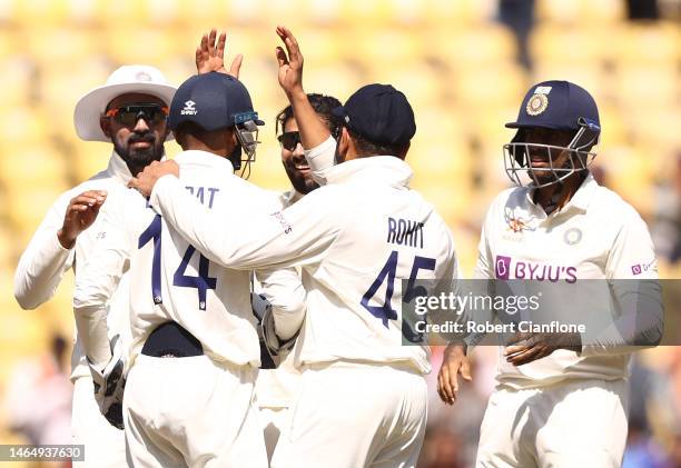 Ravindra Jadeja of India celebrates taking the wicket of Pat Cummins of Australia during day three of the First Test match in the series between...