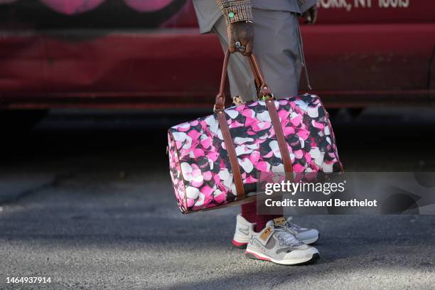 Guest wears a pale gray oversized shirt, matching pale gray sport shorts, a beige with brown and orange houndstooth print pattern bomber jacket,...