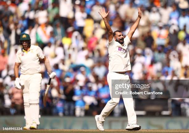 Mohammed Shami of India celebrates taking the wicket of Scott Boland of Australia to give India victory, during day three of the First Test match in...