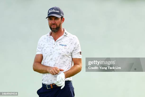 Scott Jamieson of Scotland reacts as he prepares to play his shot out of a bunker onto the 18th green during Day Three of the Singapore Classic at...