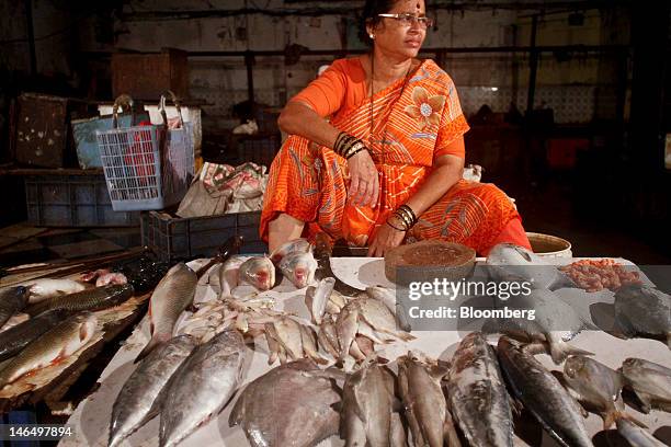 Vendor sells fish at a market in Mumbai, India, on Sunday, June 17, 2012. The Reserve Bank of India may today cut rates for a second time this year...