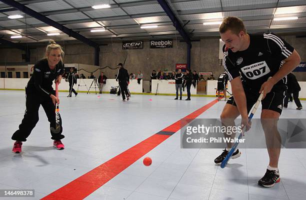 Sam Cane of the All Blacks and Charlotte Harrison of the Womens Black Sticks warm up during a cross-code training session at the Lugton Park Indoor...