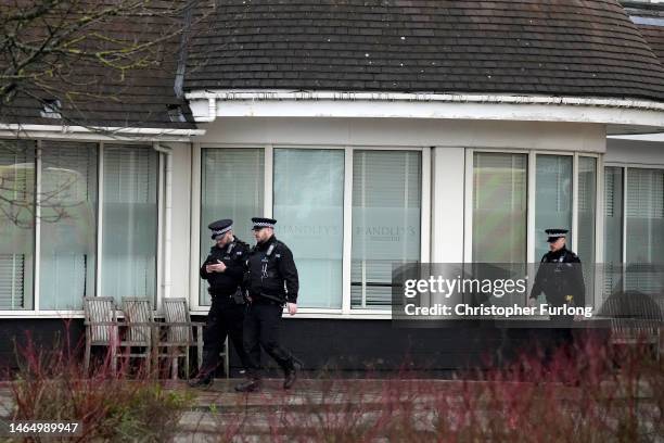 Police continue a presence outside the Suites Hotel in Knowsley, Merseyside, the morning after a protest and counter-protest on February 11, 2023 in...