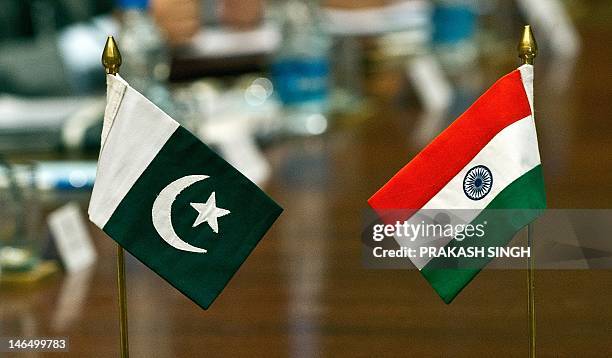 Pakistani and Indian flags stand on a table during an Indian-Pakistan meeting on the Sir Creek region in New Delhi on June 18, 2012. Pakistan and...