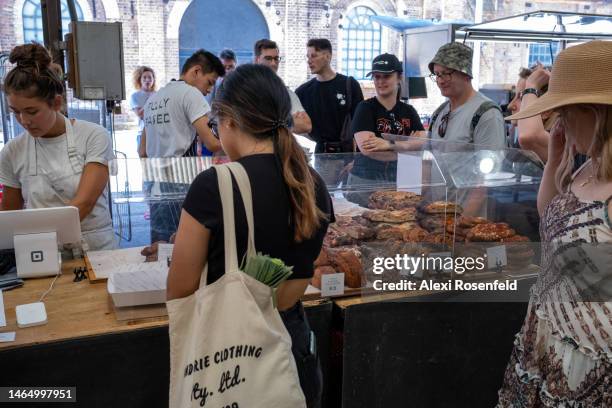 People shop at the AP Bakery stall at the Carriageworks Farmers Market on February 11, 2023 in Sydney, Australia. The weekly Carriageworks Farmers...