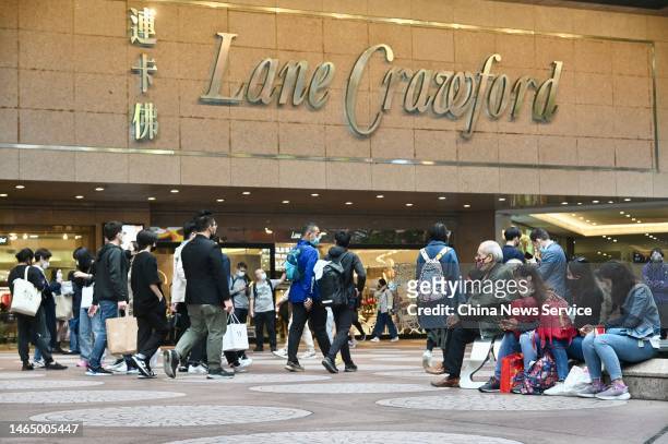 Tourists walk by a Lane Crawford store in Causeway Bay on February 11, 2023 in Hong Kong, China.