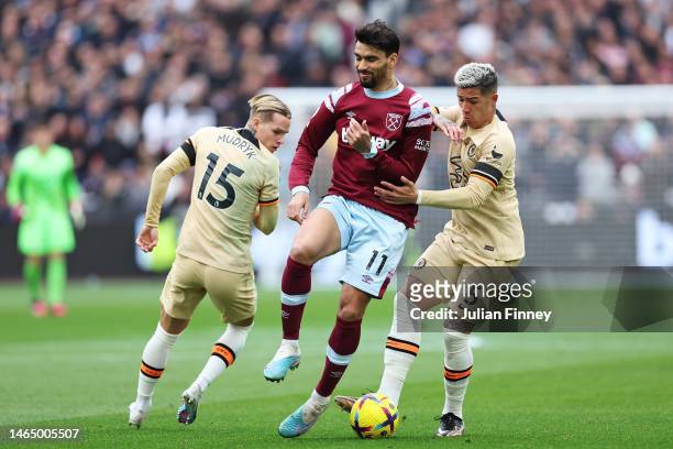 Enzo Fernandez of Chelsea battles for possession with Lucas Paqueta of West Ham United during the Premier League match between West Ham United and...