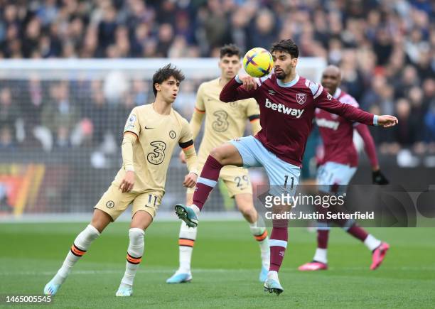 Lucas Paqueta of West Ham United controls the ball while under pressure from Joao Felix of Chelsea during the Premier League match between West Ham...