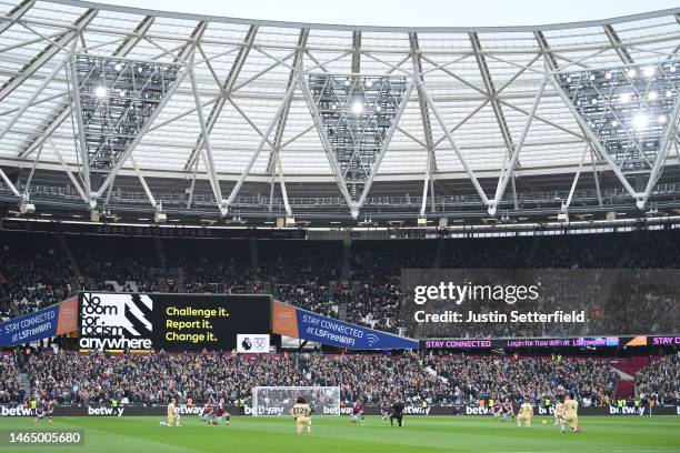 West Ham United and Chelsea FC players take a knee in support of the Black Lives Matter movement as an LED board reads 'No room for racism anywhere'...