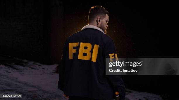 fbi agent from the back in uniform at a dark street. fbi outfit - fbi warning stock pictures, royalty-free photos & images