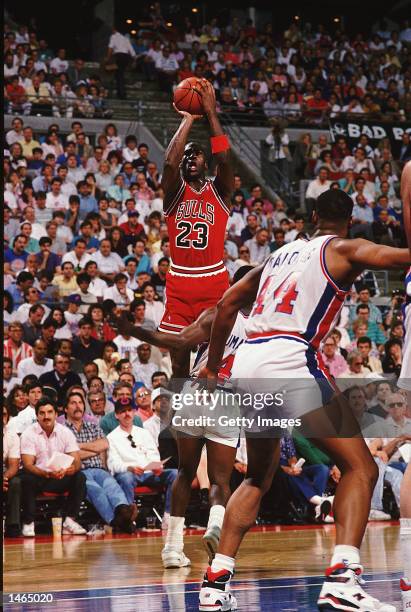 Michael Jordan of the Chicago Bulls jumps to shoot the ball during a game against the Detroit Pistons. NOTE TO USER: It is expressly understood that...