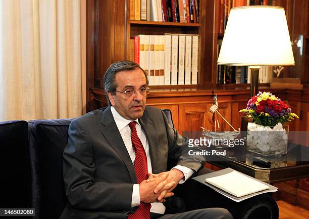 Leader of conservative New Democracy party Antonis Samaras attends a meeting with Greek President Karolos Papoulias before he receives a mandate to...