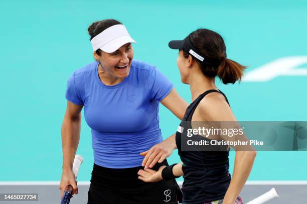 Miyu Kato of Japan and Monica Niculescu of Romania celebrate scoring a point against Luisa Stefani of Brazil and Shuai Zhang of China during their...