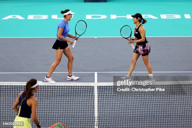 Miyu Kato of Japan and Monica Niculescu of Romania celebrate scoring a point against Luisa Stefani of Brazil and Shuai Zhang of China during their...