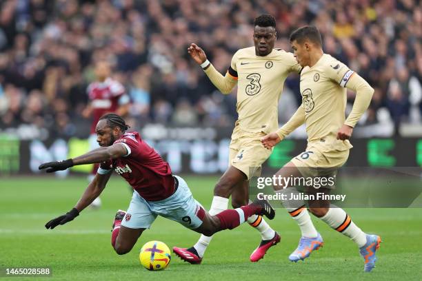 Michail Antonio of West Ham United is challenged by Benoit Badiashile and Thiago Silva of Chelsea during the Premier League match between West Ham...