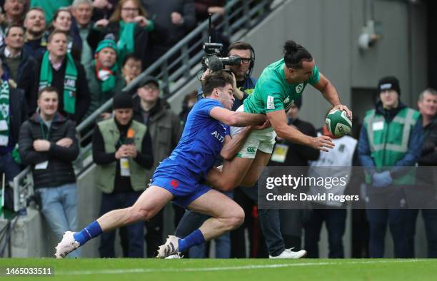 James Lowe of Ireland dives over the line in the tackle of Damian Penaud of France to score the side's second try during the Six Nations Rugby match...