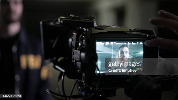 shooting a scene with an fbi agent on camera - shooting imagens e fotografias de stock