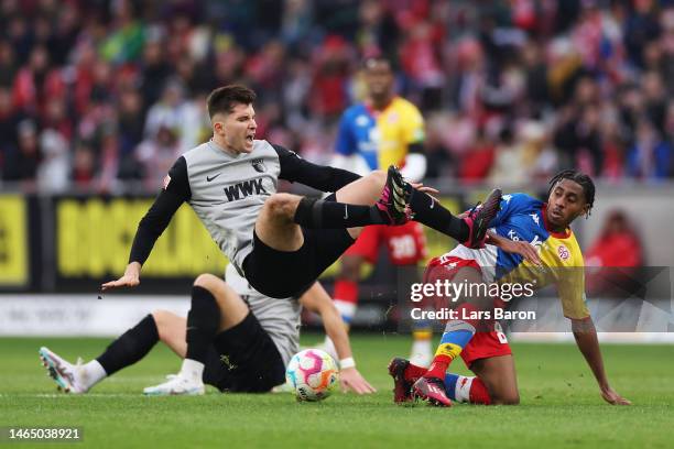 Elvis Rexhbecaj of FC Augsburg battles for possession with Leandro Barreiro of 1.FSV Mainz 05 during the Bundesliga match between 1. FSV Mainz 05 and...