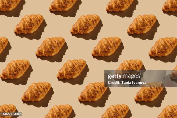 creative layout with croissants. pattern of bakery products handmade on beige background. modern minimal food photography collage in pop-art style. flat lay, top view - brioche foto e immagini stock