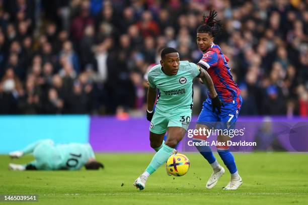 Pervis Estupinan of Brighton & Hove Albion is challenged by Michael Olise of Crystal Palace during the Premier League match between Crystal Palace...