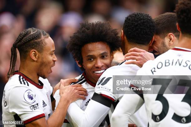 Willian of Fulham celebrates with team mates after scoring their sides first goal during the Premier League match between Fulham FC and Nottingham...