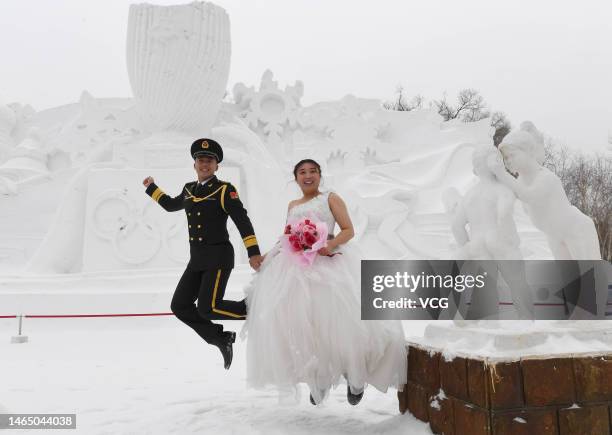 Soldiers of the People's Liberation Army and their brides attend a group wedding at the 35th Harbin Sun Island International Snow Sculpture Art Expo...