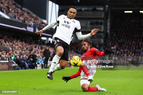 Kenny Tete of Fulham is tackled by Gustavo Scarpa of Nottingham Forest during the Premier League match between Fulham FC and Nottingham Forest at...