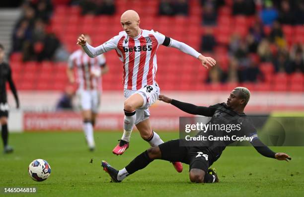 William Smallbone of Stoke is tackled by Jean Michael Seri of Hull during the Sky Bet Championship between Stoke City and Hull City at Bet365 Stadium...