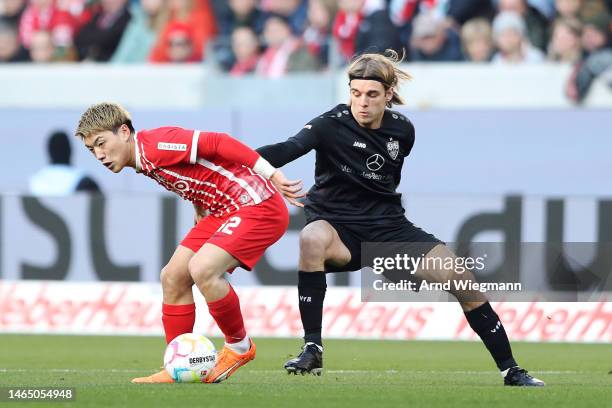 Ritsu Doan of SC Freiburg battles for possession with Borna Sosa of VfB Stuttgart during the Bundesliga match between Sport-Club Freiburg and VfB...