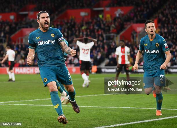 Ruben Neves and Pablo Sarabia of Wolverhampton Wanderers celebrate their team's first goal, an own goal scored by Jan Bednarek of Southampton during...