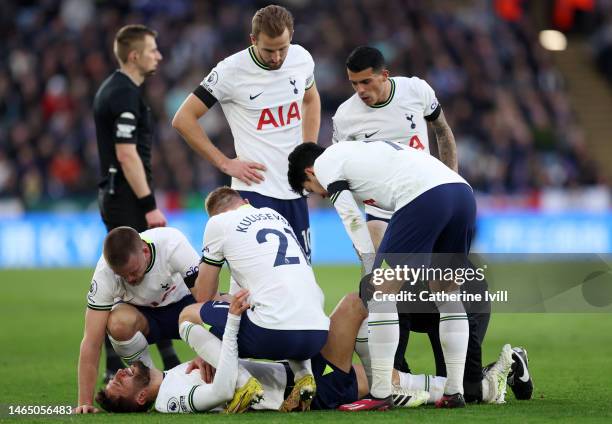 Rodrigo Bentancur of Tottenham Hotspur goes down with an injury as teammates look on during the Premier League match between Leicester City and...