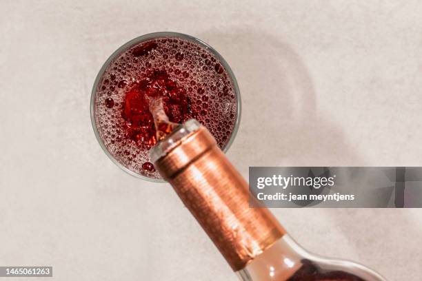 top view of a glass being filled with rosé wine - bottles glass top stock pictures, royalty-free photos & images