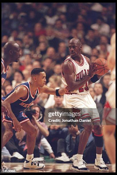 Guard John Starks of the New York Knicks tries to guard guard Michael Jordan of the Chicago Bulls at the United Center in Chicago, Illinois. The...