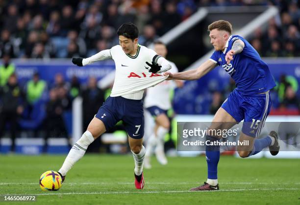 Son Heung-Min of Tottenham Hotspur is challenged by Harry Souttar of Leicester City during the Premier League match between Leicester City and...