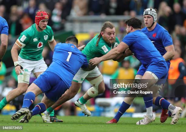 Finlay Bealham of Ireland is tackled by Cyril Baille and Julien Marchand during the Six Nations Rugby match between Ireland and France at the Aviva...