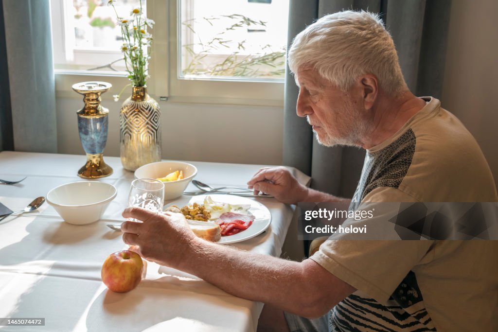 Senior men having breakfast in the hotel